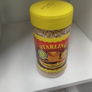 Yellow-lidded jar of Starling honey-ginger lemon tea mix on a store shelf, with a glass of tea pictured on the label